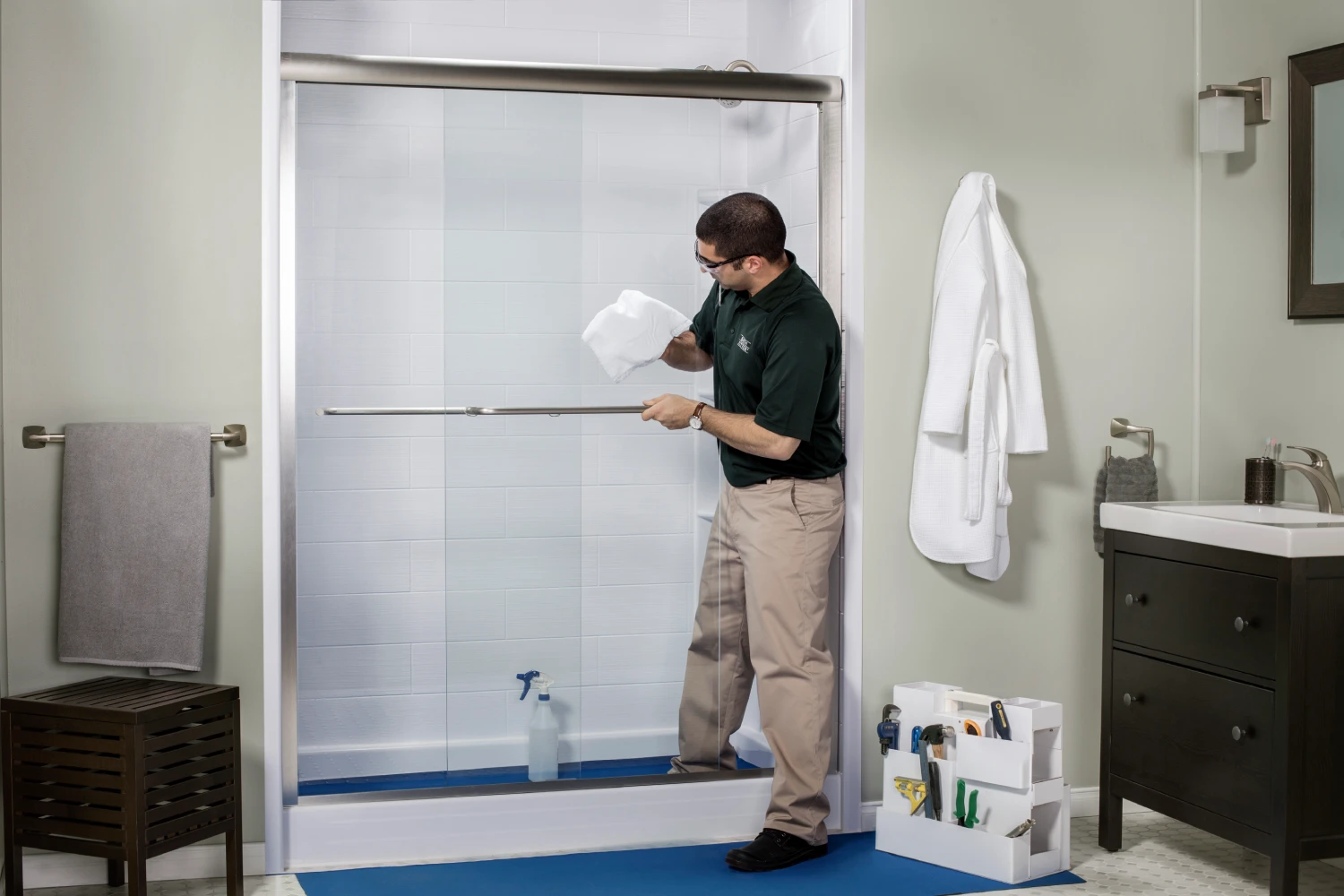 Man cleaning a shower door